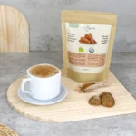 Cup of cappuccino with cinnamon powder on top along with organic Ceylon cinnamon powder package